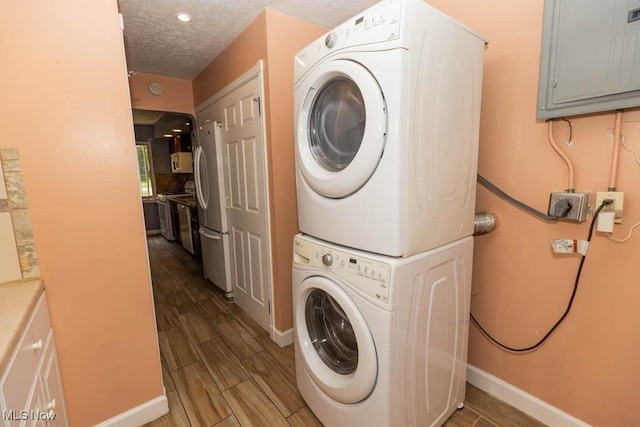 4011 Lancaster Rd, South Euclid, OH 44121 - laundry area featuring stacked washer / drying machine, electric panel, wood finished floors, and recessed lighting