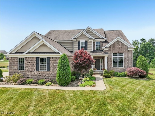 685 Shannon Pl, Aurora, OH 44202 - view of front of property with brick siding, a front lawn, and a shingled roof