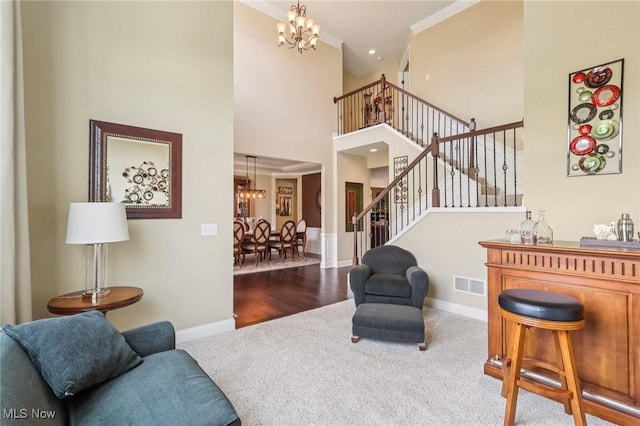 685 Shannon Pl, Aurora, OH 44202 - carpeted living room featuring a chandelier, stairway, and a towering ceiling