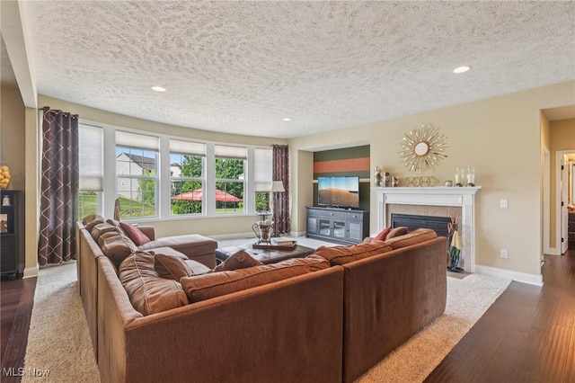 685 Shannon Pl, Aurora, OH 44202 - living room featuring a tile fireplace, a textured ceiling, recessed lighting, and dark wood-style floors