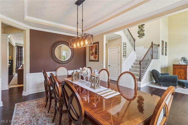 685 Shannon Pl, Aurora, OH 44202 - dining room with dark wood-style floors, stairs, ornamental molding, a raised ceiling, and wainscoting
