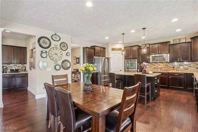 685 Shannon Pl, Aurora, OH 44202 - dining room with dark wood-type flooring, a textured ceiling, and recessed lighting
