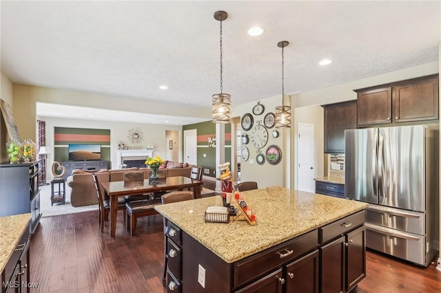 685 Shannon Pl, Aurora, OH 44202 - kitchen with freestanding refrigerator, open floor plan, a center island, light stone counters, and dark wood-type flooring