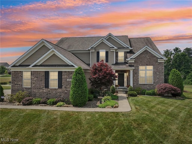 685 Shannon Pl, Aurora, OH 44202 - view of front of home with brick siding, a yard, and roof with shingles