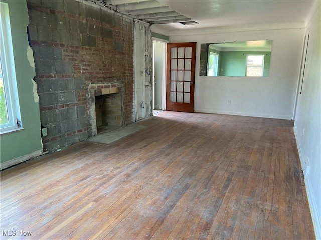 20171 Lake Shore Blvd, Euclid, OH 44123 - unfurnished living room featuring wood-type flooring and a brick fireplace