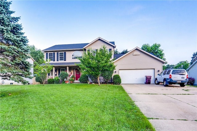 11912 Packets St NW, Canal Fulton, OH 44614 - view of front of property with driveway, a front lawn, covered porch, and an attached garage
