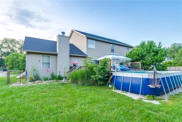 11912 Packets St NW, Canal Fulton, OH 44614 - back of house with a chimney and a shingled roof