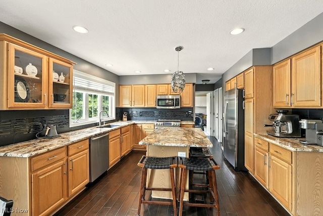 4020 Bishops Gate Cir, Stow, OH 44224 - kitchen with appliances with stainless steel finishes, a center island, light stone counters, tasteful backsplash, and recessed lighting