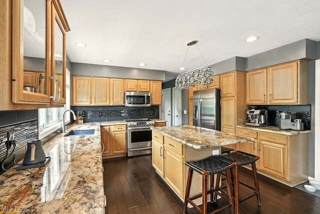 4020 Bishops Gate Cir, Stow, OH 44224 - kitchen with appliances with stainless steel finishes, light stone countertops, a center island, backsplash, and a breakfast bar