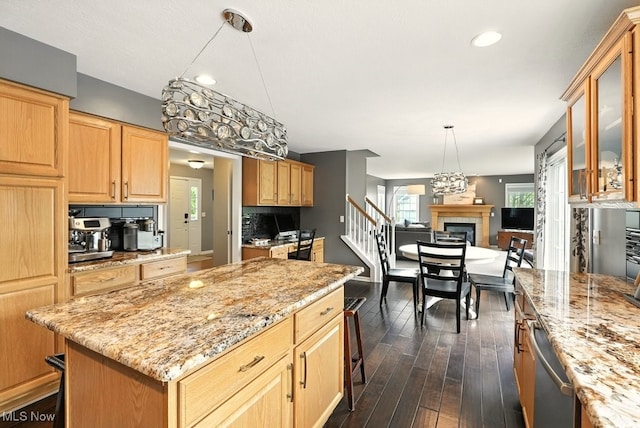 4020 Bishops Gate Cir, Stow, OH 44224 - kitchen featuring a center island, dark wood-style flooring, glass insert cabinets, dishwasher, and light stone countertops