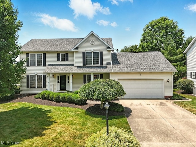 4020 Bishops Gate Cir, Stow, OH 44224 - traditional-style home featuring driveway, a garage, a front lawn, and a shingled roof