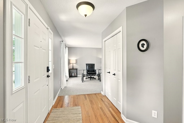 4020 Bishops Gate Cir, Stow, OH 44224 - foyer featuring healthy amount of natural light, light wood-style floors, and a textured ceiling