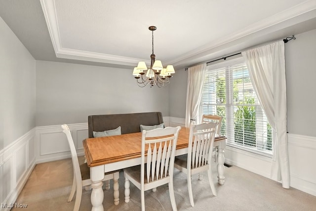 4020 Bishops Gate Cir, Stow, OH 44224 - dining area featuring light colored carpet, a chandelier, a wainscoted wall, a decorative wall, and a raised ceiling