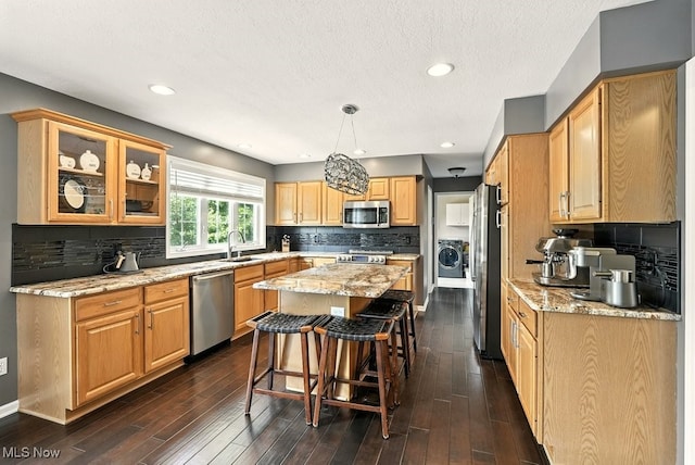 4020 Bishops Gate Cir, Stow, OH 44224 - kitchen with stainless steel appliances, a center island, light stone countertops, backsplash, and a breakfast bar area