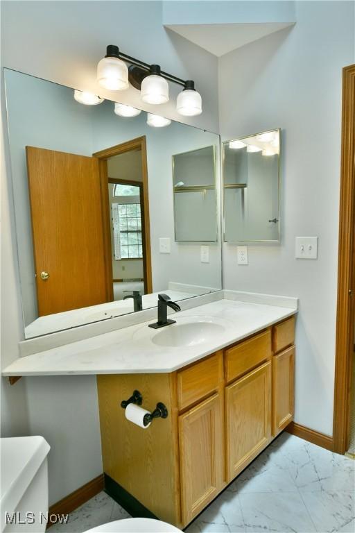 106 N Aspen Ct Unit 4, Warren, OH 44484 - half bathroom featuring vanity and marble look tiles