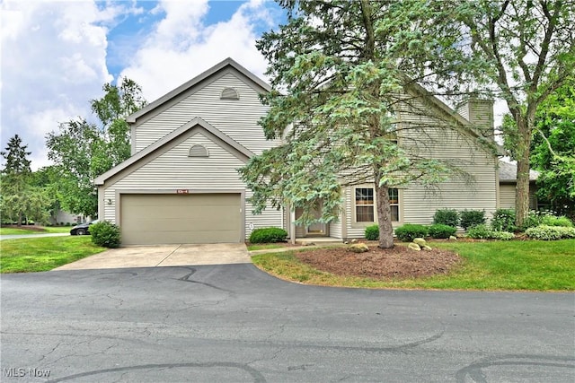 106 N Aspen Ct Unit 4, Warren, OH 44484 - view of front of property featuring driveway, a garage, a chimney, and a front lawn