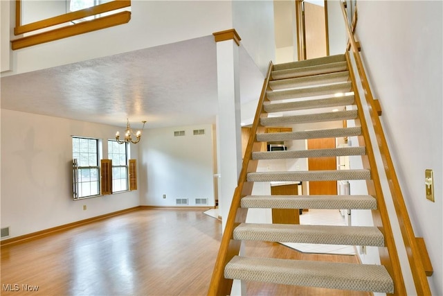 106 N Aspen Ct Unit 4, Warren, OH 44484 - stairs with a chandelier and wood finished floors