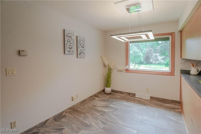 570 Rawlins Ave, New Franklin, OH 44319 - unfurnished dining area featuring baseboards
