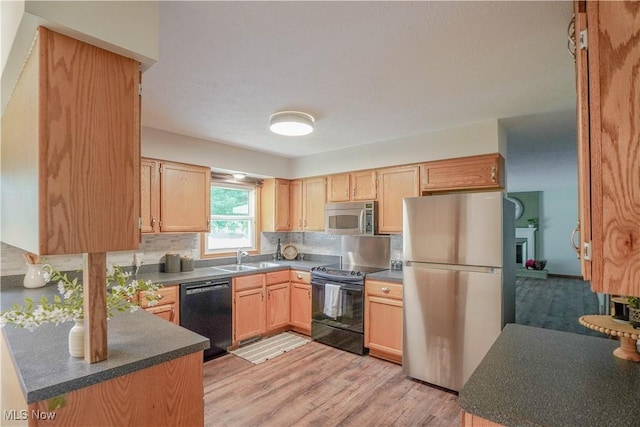 570 Rawlins Ave, New Franklin, OH 44319 - kitchen featuring black appliances, light brown cabinetry, tasteful backsplash, light wood-style flooring, and dark countertops