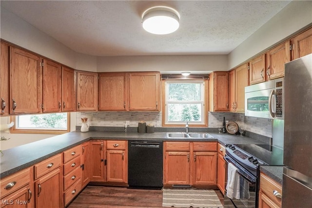 570 Rawlins Ave, New Franklin, OH 44319 - kitchen with black appliances, plenty of natural light, dark wood-style floors, dark countertops, and a textured ceiling