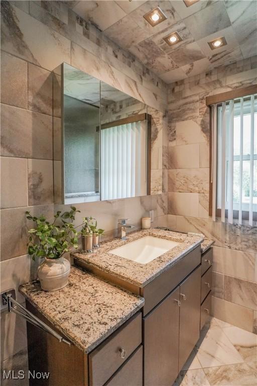 570 Rawlins Ave, New Franklin, OH 44319 - bathroom featuring tile walls and vanity