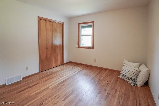 570 Rawlins Ave, New Franklin, OH 44319 - unfurnished bedroom featuring light wood-style floors and a closet
