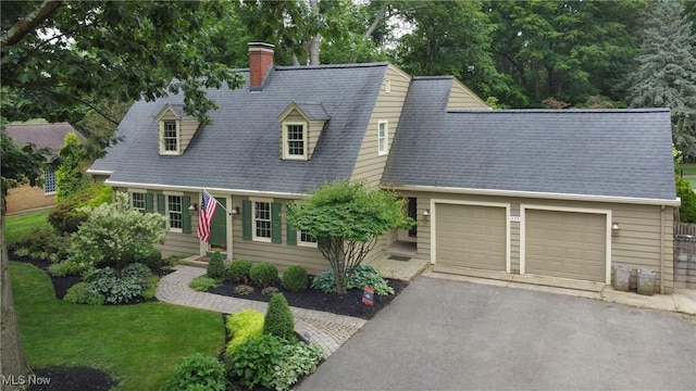 335 N Union Ave, Salem, OH 44460 - new england style home featuring a chimney, an attached garage, and driveway