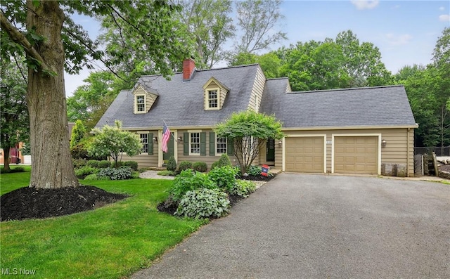 335 N Union Ave, Salem, OH 44460 - new england style home featuring a garage, driveway, a chimney, and a front yard