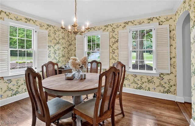 335 N Union Ave, Salem, OH 44460 - dining area featuring wood finished floors, plenty of natural light, wallpapered walls, a chandelier, and arched walkways