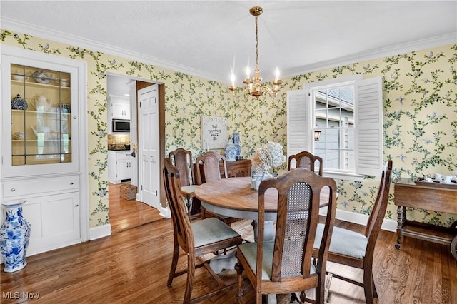 335 N Union Ave, Salem, OH 44460 - dining space featuring wallpapered walls, wood finished floors, a chandelier, and crown molding