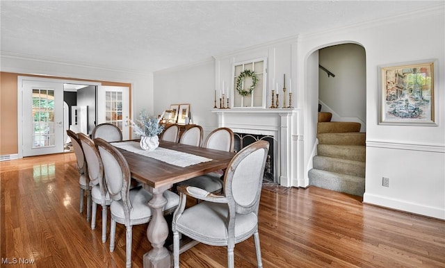 335 N Union Ave, Salem, OH 44460 - dining room featuring wood finished floors, stairs, crown molding, arched walkways, and a textured ceiling