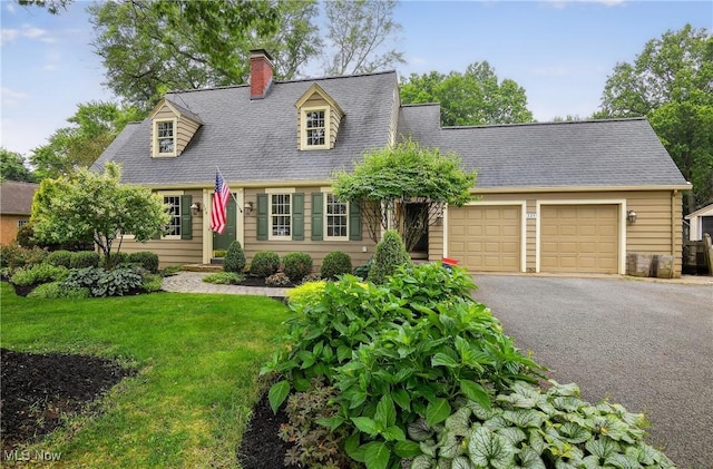 335 N Union Ave, Salem, OH 44460 - cape cod-style house with asphalt driveway, a chimney, a garage, a front lawn, and roof with shingles