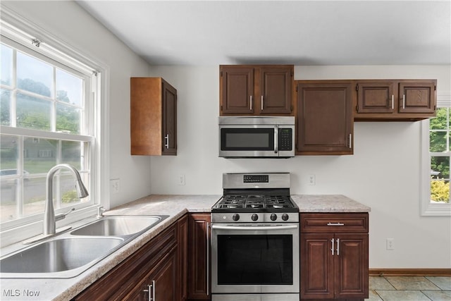 1241 Sparhawk Ave, Akron, OH 44305 - kitchen with appliances with stainless steel finishes, light countertops, and light tile patterned flooring