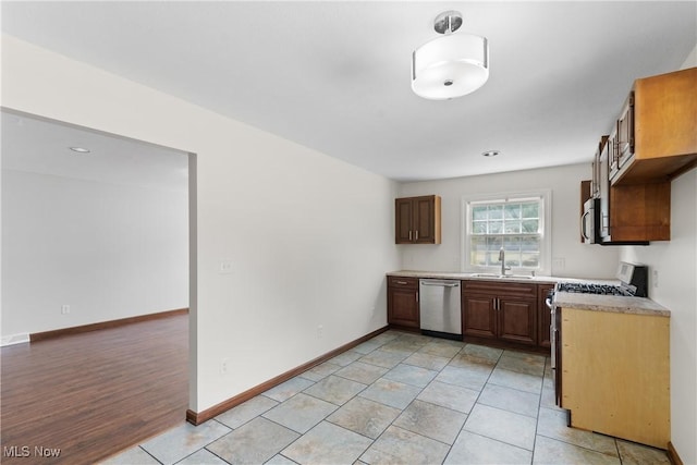 1241 Sparhawk Ave, Akron, OH 44305 - kitchen featuring stainless steel appliances, light countertops, and light tile patterned floors