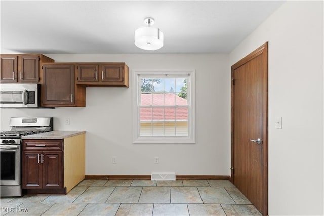 1241 Sparhawk Ave, Akron, OH 44305 - kitchen with stainless steel appliances, light countertops, and light tile patterned floors
