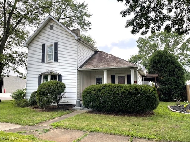 444 5th St NW, New Philadelphia, OH 44663 - traditional-style home featuring a front lawn, a chimney, and roof with shingles