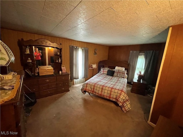 444 5th St NW, New Philadelphia, OH 44663 - bedroom featuring carpet floors, multiple windows, and wood walls