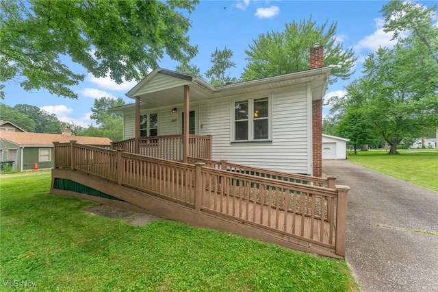 2045 Overland Ave NE, Warren, OH 44483 - view of front facade with an outdoor structure, a chimney, a front yard, and a wooden deck