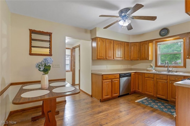 2045 Overland Ave NE, Warren, OH 44483 - kitchen with stainless steel dishwasher, brown cabinetry, light wood-style floors, a ceiling fan, and light countertops