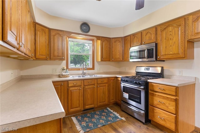 2045 Overland Ave NE, Warren, OH 44483 - kitchen featuring stainless steel appliances, brown cabinetry, and light countertops