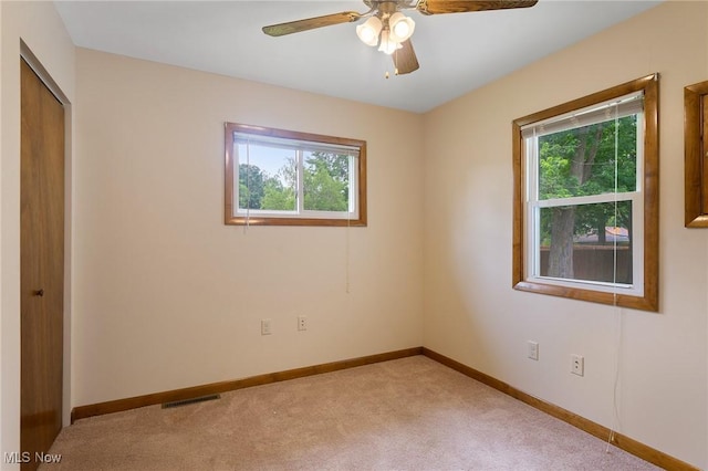 2045 Overland Ave NE, Warren, OH 44483 - unfurnished bedroom featuring multiple windows, light carpet, a closet, and ceiling fan