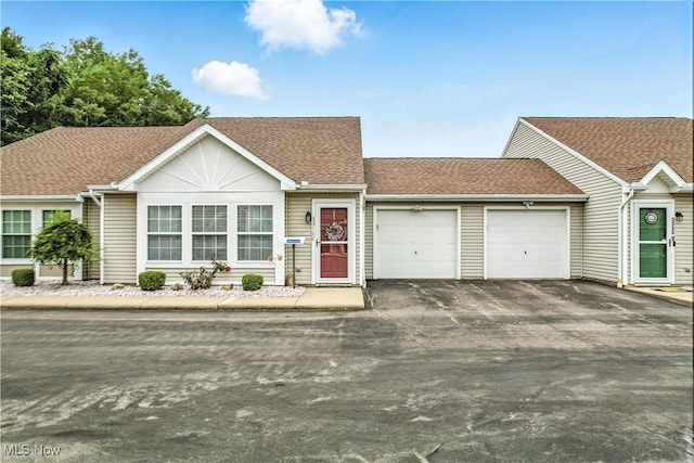 3310 Trappers Trl Unit C, Cortland, OH 44410 - single story home with a garage, asphalt driveway, and a shingled roof