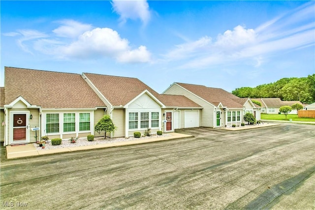 3310 Trappers Trl Unit C, Cortland, OH 44410 - single story home featuring a garage, roof with shingles, and driveway