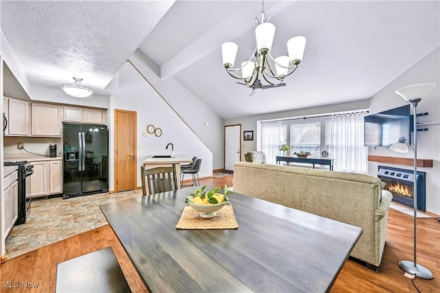 3310 Trappers Trl Unit C, Cortland, OH 44410 - dining room with light wood-style floors, a chandelier, and a textured ceiling