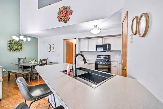 3310 Trappers Trl Unit C, Cortland, OH 44410 - kitchen with stainless steel microwave, black range with gas cooktop, a chandelier, a breakfast bar area, and light countertops