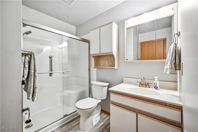 3310 Trappers Trl Unit C, Cortland, OH 44410 - bathroom featuring vanity, a shower stall, wood finished floors, and a textured ceiling