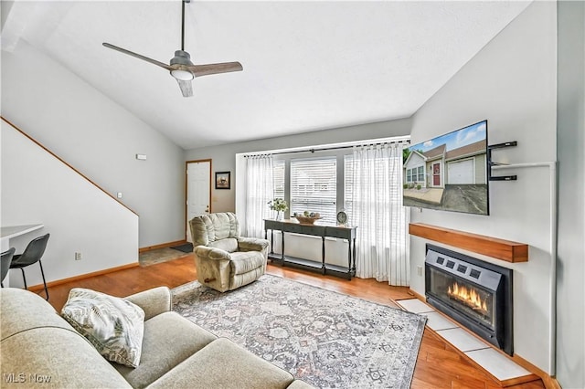 3310 Trappers Trl Unit C, Cortland, OH 44410 - living room with lofted ceiling, a ceiling fan, a fireplace with flush hearth, and wood finished floors