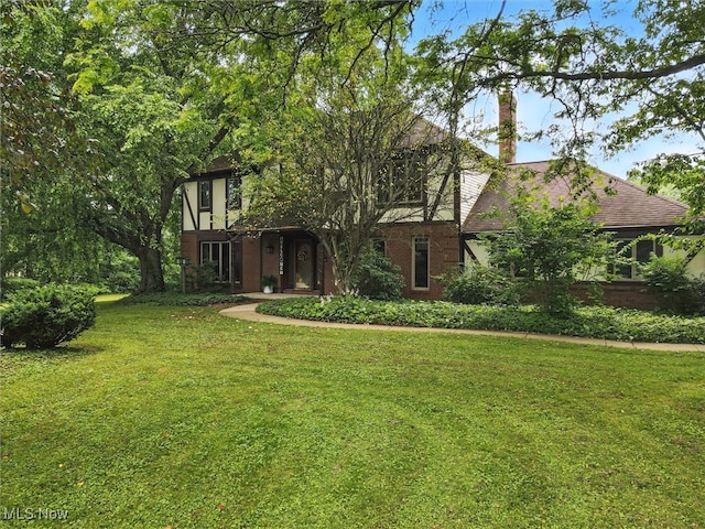 19070 Ridgeview Trl, Chagrin Falls, OH 44023 - english style home with a front yard, brick siding, and a chimney