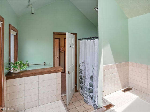 19070 Ridgeview Trl, Chagrin Falls, OH 44023 - bathroom with vaulted ceiling, tile patterned floors, and a bathtub