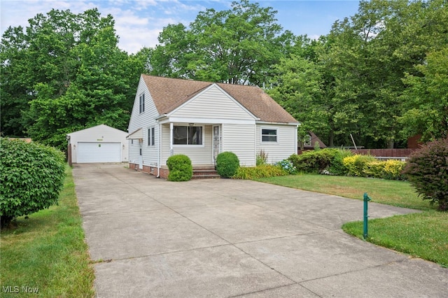 3016 Clague Rd, North Olmsted, OH 44070 - bungalow-style home with an outdoor structure, a garage, a front yard, and roof with shingles